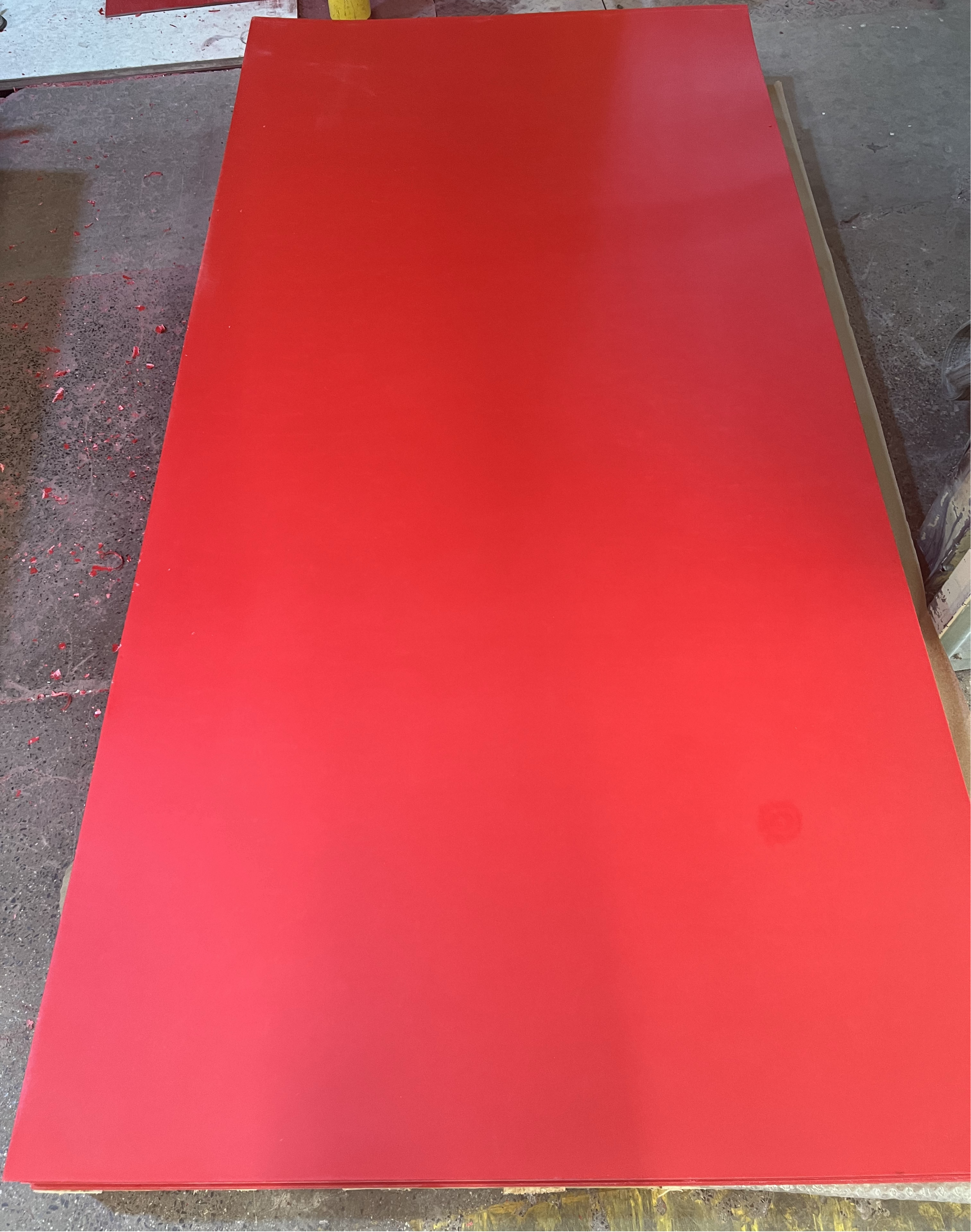 Red GPO-3 UPGM-203 insulation sheets stacked on pallets for industrial use